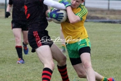 Donegal's Kyle Mc Nulty keeps possesion against Tyrone in Magheragallon on Saturday.