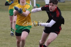 Donegal's Kyle Mc Nulty in a chase for the ball against Tyrone in Magheragallon on Saturday.