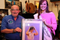 Kevin Bonner of Bonner's, Dungloe presenting a painting to outgoing Mary from Dungloe winner Caroline O'Donnell of her winning moment as captured last year by photographer Eoin Mc Garvey. Kevin has been involved with the Mary festival for many years.